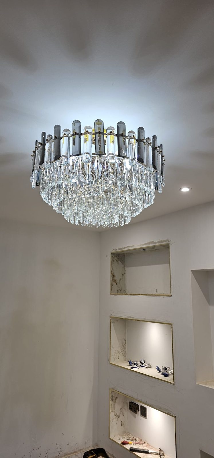 Smoked and clear crystal chandelier installed by Z Electricals as part of a whole-house lighting project